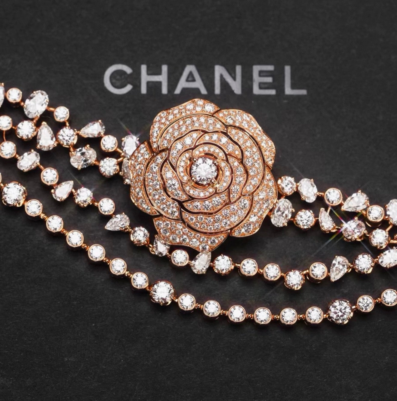 Chanel "Camélia Garden" high jewelry collection features a rose gold tassel chain with full diamonds, detachable camellia brooch, bracelet, and bangle.