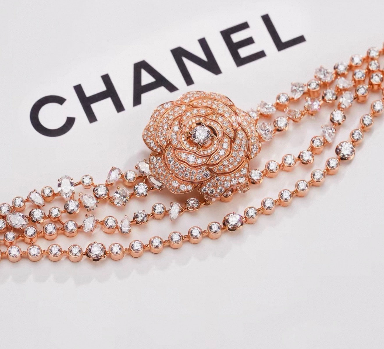 Chanel "Camélia Garden" high jewelry collection features a rose gold tassel chain with full diamonds, detachable camellia brooch, bracelet, and bangle.